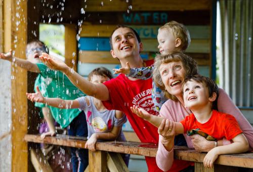 Family enjoying the monsoon shack in the Rainforest Biome